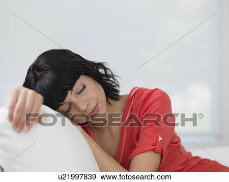 Young woman resting on sofa View Large Photo Image Stock Photo - Young woman resting on sofa. Fotosearch