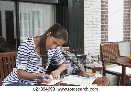 Young woman with backpack planning her journey View Large Photo Image Stock Image - Young woman with backpack planning her journey. Fotosearch