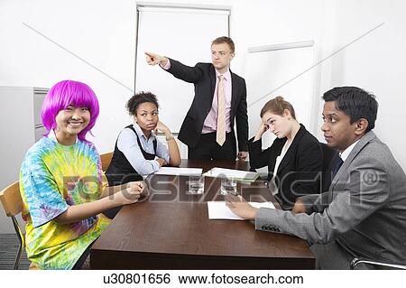Angry multiethnic businesspeople with colleague in pink wig at meeting View Large Photo Image Stock Photograph - Angry multiethnic businesspeople with colleague in pink wig at meeting. Fotosearch