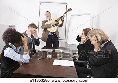 Businessman playing guitar in business meeting View Large Photo Image Stock Photograph - Businessman playing guitar in business meeting. Fotosearch