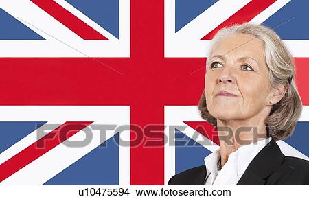 Picture - Close-up of senior businesswoman over British flag. Fotosearch