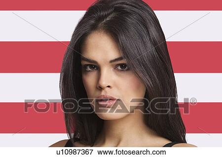 Close-up portrait of young woman against American flag View Large Photo Image Stock Photo - Close-up portrait of young woman against American flag. Fotosearch