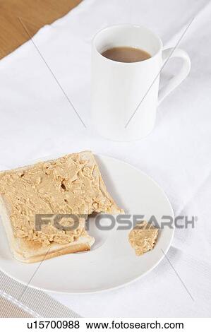 Coffee mug and peanut butter on wheat bread View Large Photo Image Stock Photo - Coffee mug and peanut butter on wheat bread. Fotosearch