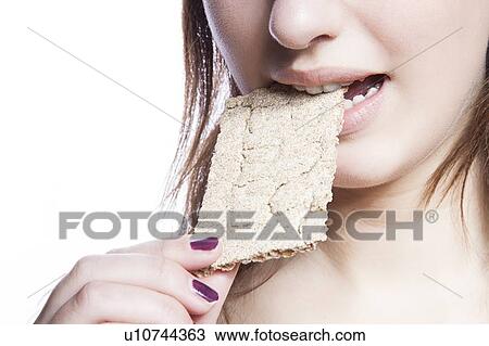 Detail shot of woman eating crispbread over white background View Large Photo Image Stock Image - Detail shot of woman eating crispbread over white background. Fotosearch