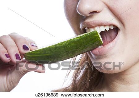 Detail shot of woman eating cucumber over white background View Large Photo Image Stock Photo - Detail shot of woman eating cucumber over white background. Fotosearch