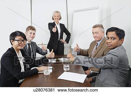 Multiethnic business people giving thumbs up in meeting View Large Photo Image Stock Image - Multiethnic business people giving thumbs up in meeting. Fotosearch