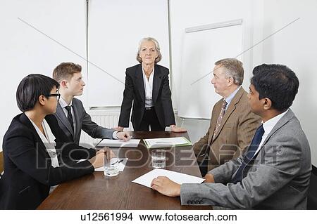 Multiethnic businesspeople at meeting in conference room View Large Photo Image Picture - Multiethnic businesspeople at meeting in conference room. Fotosearch