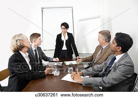 Multiethnic businesspeople at meeting in conference room View Large Photo Image Stock Image - Multiethnic businesspeople at meeting in conference room. Fotosearch
