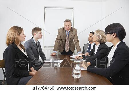 Multiethnic businesspeople at meeting in conference room View Large Photo Image Stock Photograph - Multiethnic businesspeople at meeting in conference room. Fotosearch