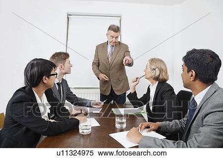 Multiethnic businesspeople at meeting in conference room View Large Photo Image Stock Photography - Multiethnic businesspeople at meeting in conference room. Fotosearch