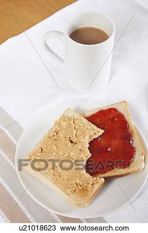 Peanut butter and jam on slices of bread with cup of coffee View Large Photo Image Stock Image - Peanut butter and jam on slices of bread with cup of coffee. Fotosearch