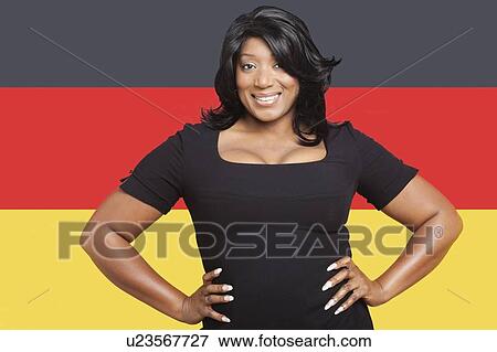 Portrait of casual mixed race woman against German flag View Large Photo Image Stock Photo - Portrait of casual mixed race woman against German flag. Fotosearch