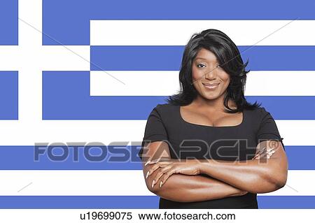 Stock Photography - Portrait of casual mixed race woman against Greek flag. Fotosearch