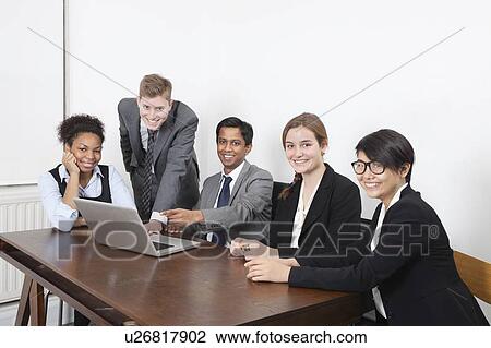 Portrait of multiethnic professionals using laptop at conference room View Large Photo Image Stock Image - Portrait of multiethnic professionals using laptop at conference room. Fotosearch