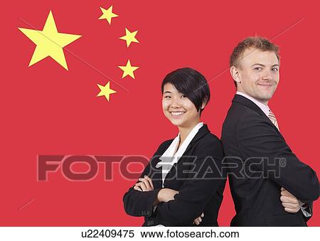 Stock Photography - Portrait of young businesswoman and man smiling over Chinese flag. Fotosearch