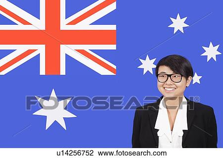 Portrait of young businesswoman smiling over Australian flag View Large Photo Image Stock Image - Portrait of young businesswoman smiling over Australian flag. Fotosearch
