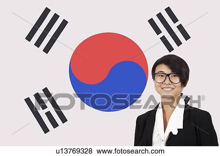 Stock Photo - Portrait of young businesswoman smiling over Korean flag. Fotosearch