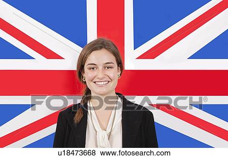 Portrait of young businesswoman smiling over British flag View Large Photo Image Stock Photo - Portrait of young businesswoman smiling over British flag. Fotosearch