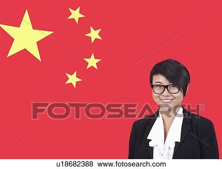 Stock Photo - Portrait of young businesswoman smiling over Chinese flag. Fotosearch