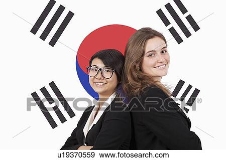 Stock Photo - Portrait of young multiethnic businesswomen smiling over Korean flag. Fotosearch