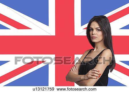 Stock Photo - Portrait of young woman against British flag. Fotosearch