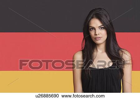 Portrait of young woman against German flag View Large Photo Image Stock Image - Portrait of young woman against German flag. Fotosearch