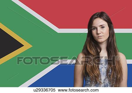 Stock Photography - Portrait of young woman against South African flag. Fotosearch