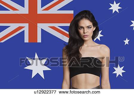 Stock Photo - Portrait of young woman in tube bra against Australian flag. Fotosearch