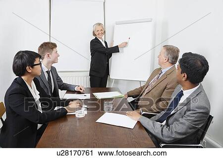 Senior woman using whiteboard in business meeting View Large Photo Image Stock Image - Senior woman using whiteboard in business meeting. Fotosearch