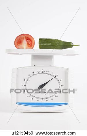 Vegetables measured on scale over white background View Large Photo Image Stock Photo - Vegetables measured on scale over white background. Fotosearch