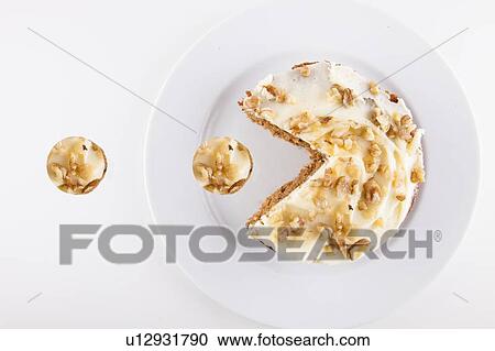 Stock Image - Walnut cake in plate over white background. Fotosearch