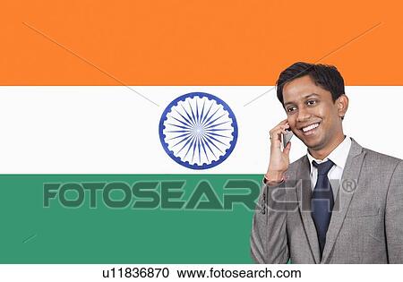 Young businessman using cell phone over Indian flag View Large Photo Image Stock Image - Young businessman using cell phone over Indian flag. Fotosearch