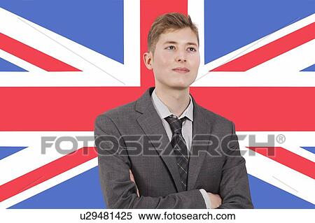 Stock Photography - Young businessman with arms crossed over British flag. Fotosearch
