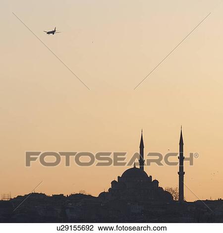 Stock Image - Airplane in flight over Suleymaniye Mosque, Third Hill, Istanbul, Turkey. Fotosearch