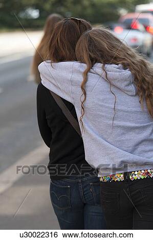 Stock Photograph - Back view of daughter hugging her mother, District 2, Zurich, Switzerland. Fotosearch