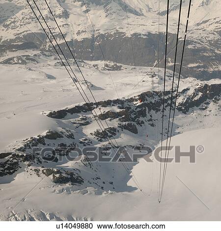 Cables of overhead cable cars in a snowy valley, Zermatt, Valais Canton, Switzerland View Large Photo Image Stock Image - Cables of overhead cable cars in a snowy valley, Zermatt, Valais Canton, Switzerland. Fotosearch