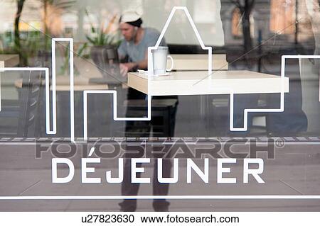 Stock Image - Close-up of a sign on the glass window of a restaurant, Mile-End, Montreal, Quebec, Canada. Fotosearch