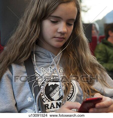 Close-up of a teenage girl listening to music, Chamonix, Rhone-Alpes, France View Large Photo Image Picture - Close-up of a teenage girl listening to music, Chamonix, Rhone-Alpes, France. Fotosearch