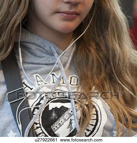 Stock Image - Close-up of a teenage girl listening to music, Chamonix, Rhone-Alpes, France. Fotosearch