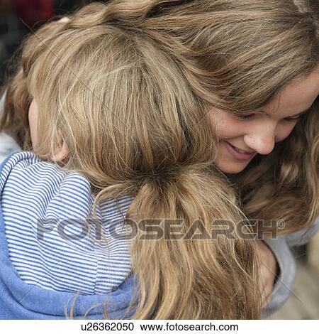 Close-up of two girls hugging each other, Istanbul, Turkey View Large Photo Image Stock Image - Close-up of two girls hugging each other, Istanbul, Turkey. Fotosearch