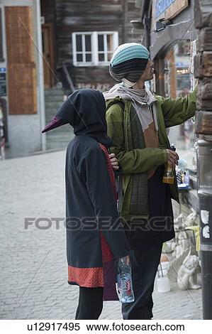 Stock Photography - Couple shopping on a small street shop, Zermatt, Valais Canton, Switzerland. Fotosearch