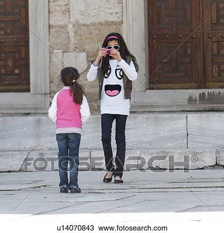 Girl taking picture of her sister at Blue Mosque, Istanbul, Turkey View Large Photo Image Stock Image - Girl taking picture of her sister at Blue Mosque, Istanbul, Turkey. Fotosearch