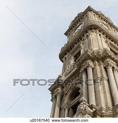 Stock Image - Low angle view of the clock tower at Dolmabahce Palace, Istanbul, Turkey. Fotosearch