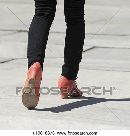 Stock Image - Low section view of a woman walking at Blue Mosque, Istanbul, Turkey. Fotosearch