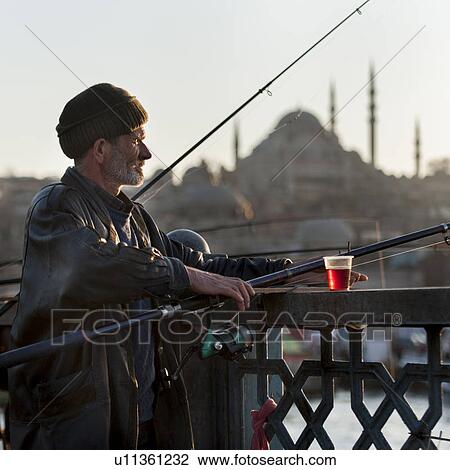 Man fishing in a river with Rustem Pasha Mosque in the background, Bosphorus River, Istanbul, Turkey View Large Photo Image Stock Image - Man fishing in a river with Rustem Pasha Mosque in the background, Bosphorus River, Istanbul, Turkey. Fotosearch