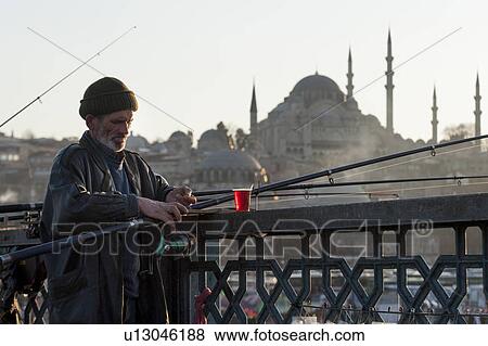 Man fishing in a river with Rustem Pasha Mosque in the background, Bosphorus River, Istanbul, Turkey View Large Photo Image Stock Photo - Man fishing in a river with Rustem Pasha Mosque in the background, Bosphorus River, Istanbul, Turkey. Fotosearch