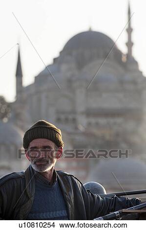 Man fishing with Rustem Pasha Mosque in the background, Bosphorus River, Istanbul, Turkey View Large Photo Image Picture - Man fishing with Rustem Pasha Mosque in the background, Bosphorus River, Istanbul, Turkey. Fotosearch