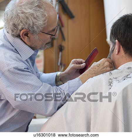 Stock Photo - Man receiving a hair cut from barber, Istanbul, Turkey. Fotosearch