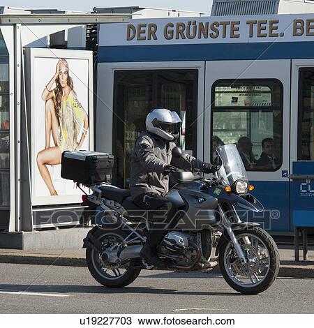 Stock Image - Man riding a motorcycle, Bahnhofstrasse, Zurich, Switzerland. Fotosearch