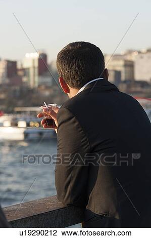 Man standing on the Galata Bridge having soft drink, Bosphorus River, Istanbul, Turkey View Large Photo Image Stock Image - Man standing on the Galata Bridge having soft drink, Bosphorus River, Istanbul, Turkey. Fotosearch